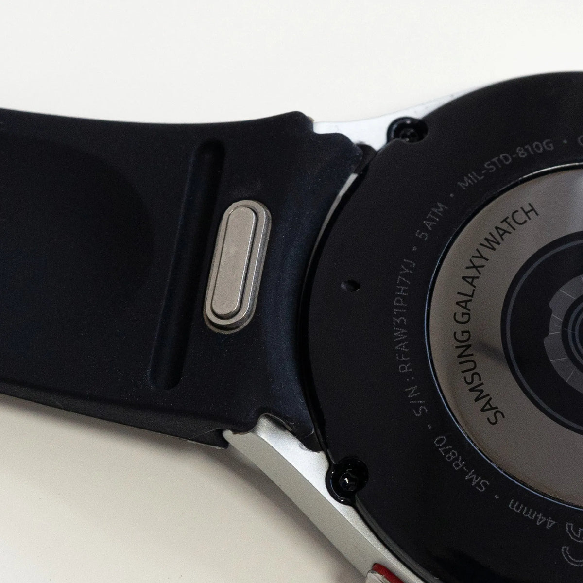 Silicone Strap 'One Push', black, on a watch, 3/4 rear view